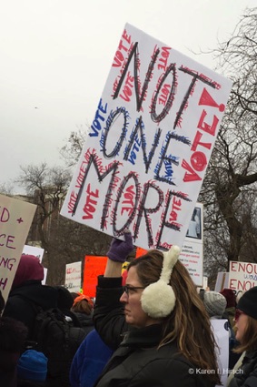 Woman holding up sign Not One More